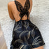 Black satin dress with gold leaf print and butterfly back detail