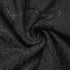 Swirled black lace fabric, highlighting soft texture and elegant floral lace detailing.