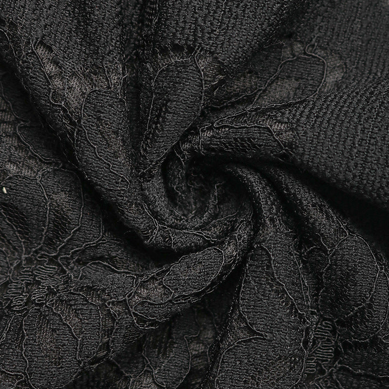 Swirled black lace fabric, highlighting soft texture and elegant floral lace detailing.