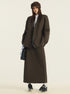 Dark brown wool blazer and maxi skirt set styled with white top, newsboy cap and black loafers