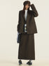 Full-length view of brown wool suit set with product tag, styled with black messenger bag