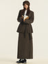 Front view of brown blazer and skirt set with book accessory, showcasing classic tailoring
