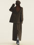 Back view of brown wool suit set showing long skirt with side slit and oversized blazer fit
