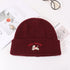 Burgundy winter beanie with Lucky Pipiegg logo against white background