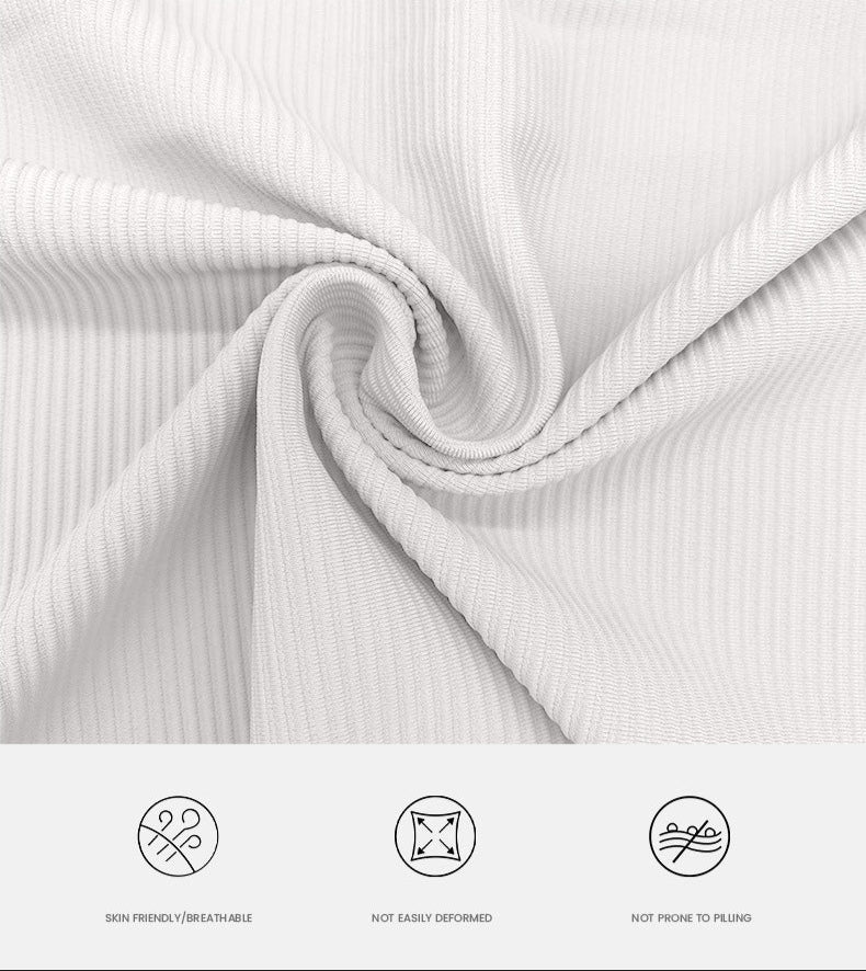 Close-up of cream ribbed fabric texture twisted to show elasticity, detailed shot showing quality and stretch properties
