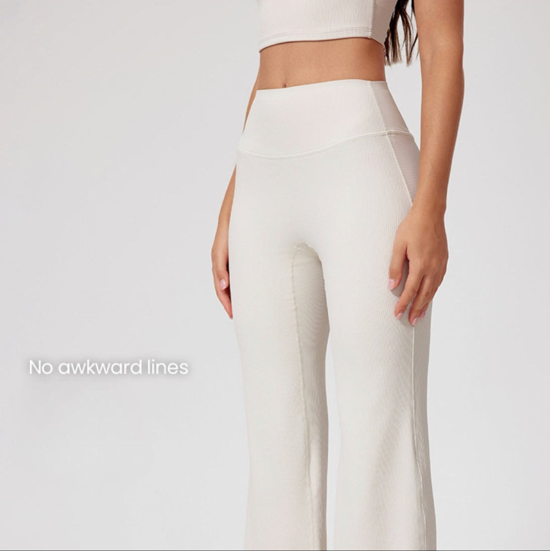 Close-up of cream workout pants with high waistband, 'No awkward lines' text overlay, smooth ribbed texture, seamless construction
