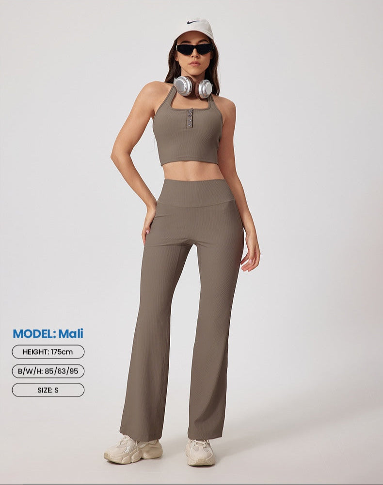 Model wearing taupe ribbed workout set - crop top with button detail, high-waist pants, white Nike cap, black sunglasses, headphones