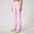 Soft pink ribbed yoga pants with high waistband, wide leg cut, light compression fit, cream chunky sneakers, athleisure style