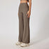 Taupe ribbed yoga pants with high waist design, wide leg silhouette, seamless construction, neutral chunky sneakers, minimal styling