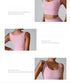 A woman wearing a pink ribbed sports bra shown from multiple angles highlighting stretch features, sleeveless design and seamless construction for fitness training