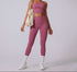 Model in dusty rose workout set with high-waisted leggings, crop top, white sneakers, and cream tote bag