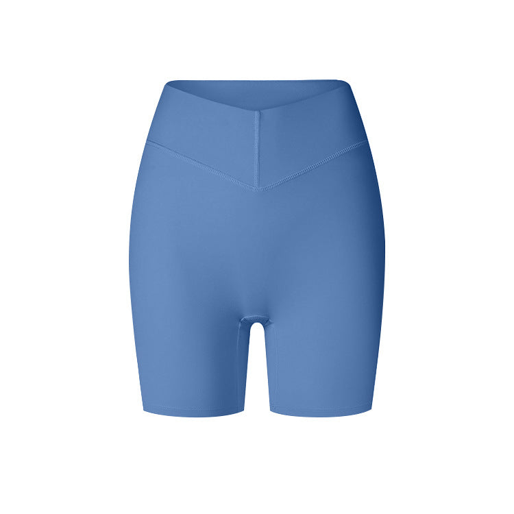 A product image showing blue high-waisted compression biker shorts with V-shaped front seam and smooth finish against white backdrop