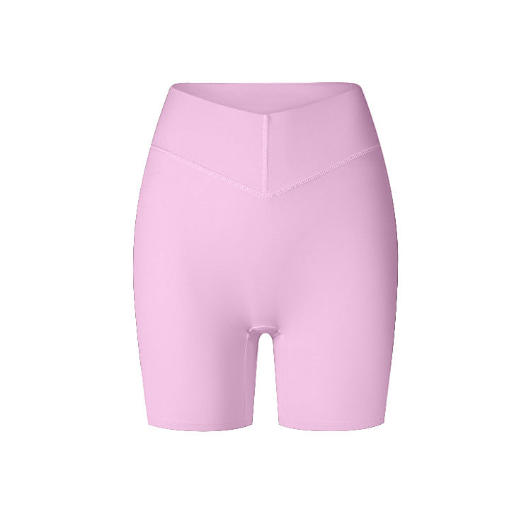 A product image displaying soft pink high-waisted compression shorts with V-shaped waistband and mid-thigh length against white background