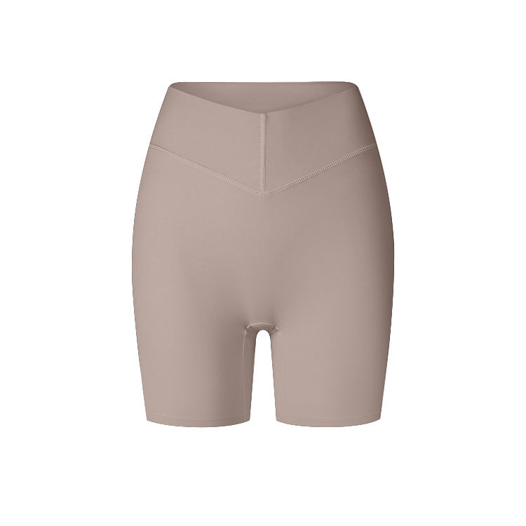 A product image featuring taupe high-waisted compression shorts with V-shaped front panel and seamless design against white background