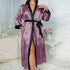 Purple satin robe with heart and "love" print, black trim, worn in bedroom setting