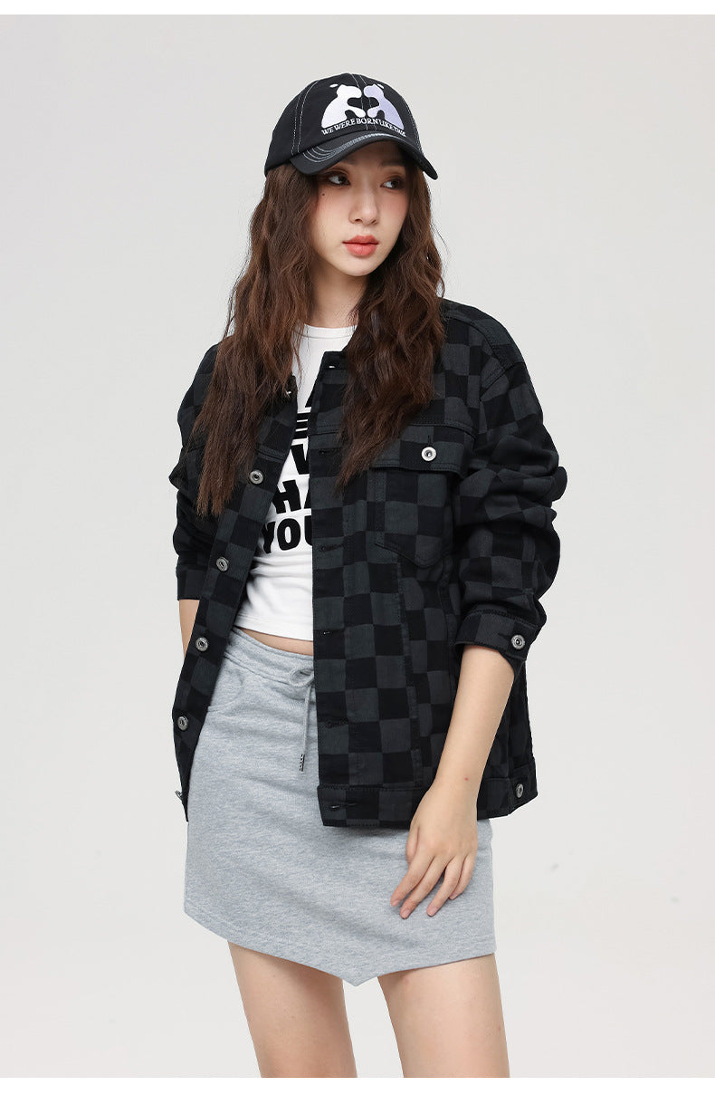 Close-up of black checkered jacket with graphic tee and grey skirt combo