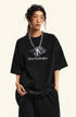 Side profile of model in black Backstairs t-shirt with logo and relaxed pants