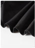 Close-up of black pleated fabric showing hem stitching detail against white background