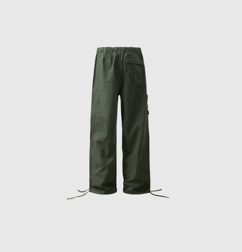 Back view of olive green cargo pants with elastic waistband and utility pockets, featuring drawstring ankle closures