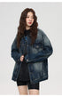 Close-up shot of female model in oversized denim jacket and black t-shirt