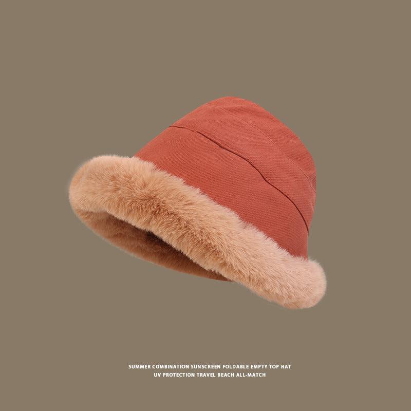Terracotta bucket hat with soft beige faux fur trim, textured fabric, short brim, cozy winter style, neutral taupe background