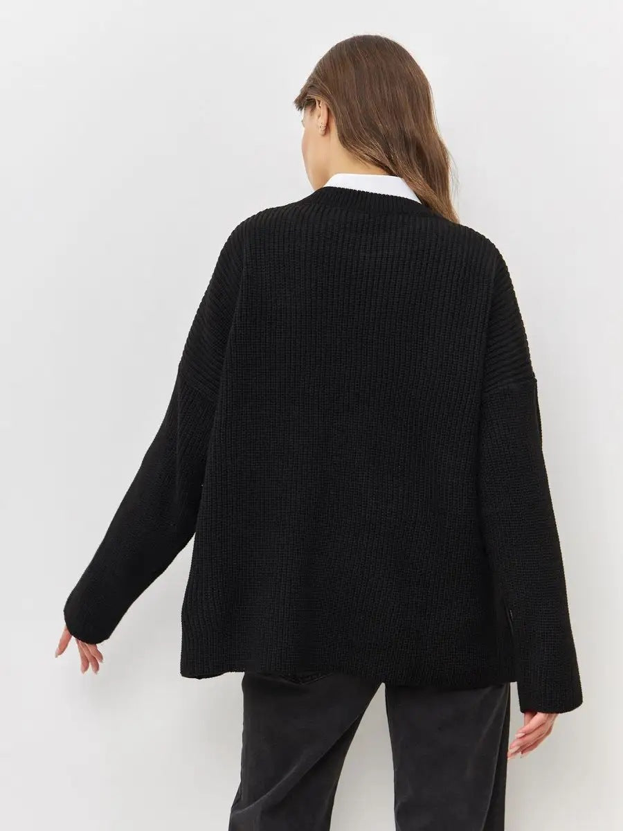 Back view of black ribbed knit sweater showing oversized silhouette and dropped shoulders