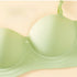Close-up of a light green bra’s molded cup with a butterfly detail, highlighting smooth, seamless support.