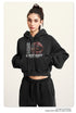 Black cropped hoodie with graphic print, close-up front view