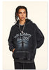 Model in black graphic hoodie with "Win Against All Odds" text, side profile in studio