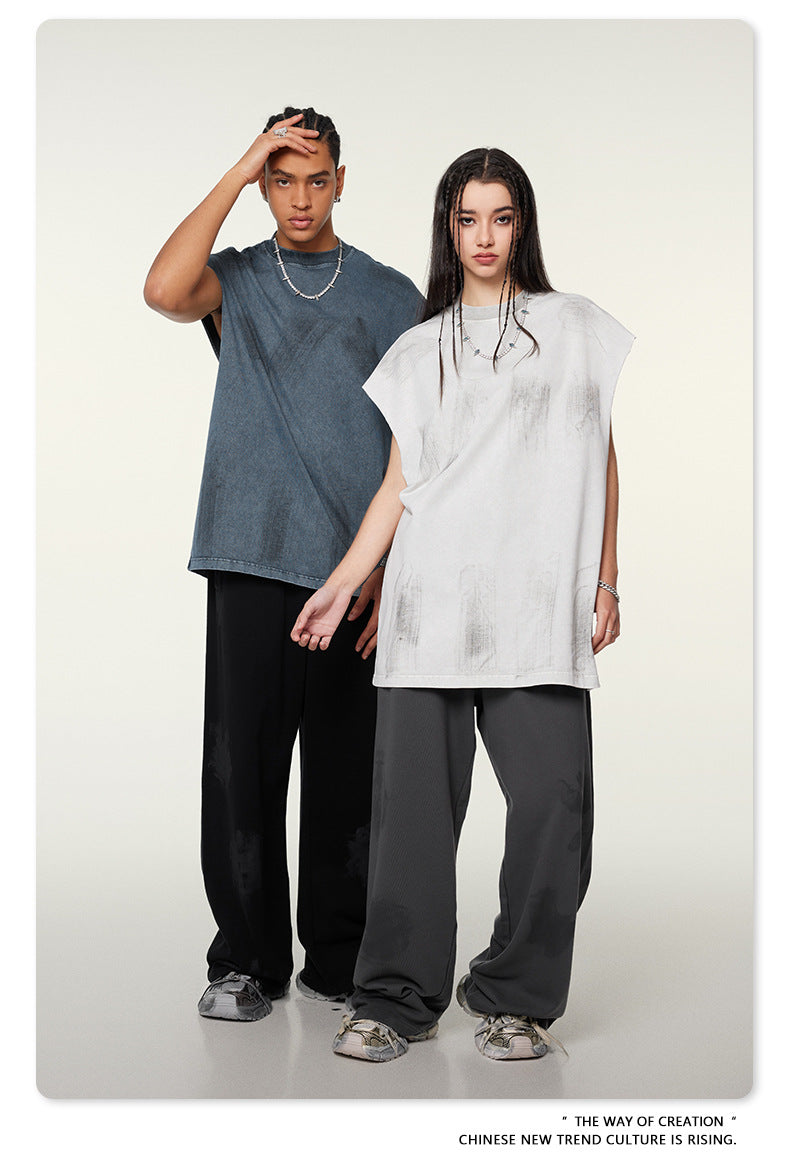 Two models in oversized t-shirts - gray and white - with wide-leg pants and silver sneakers against cream background