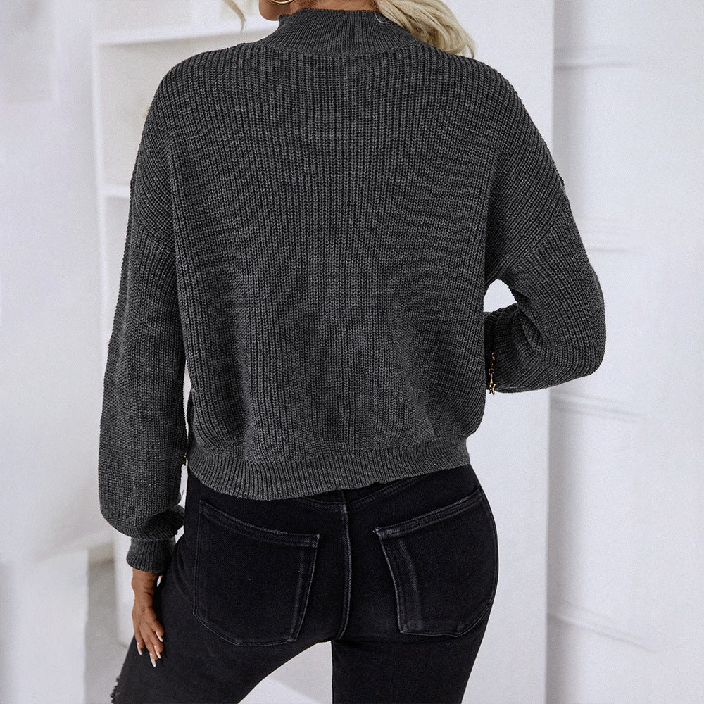 Back view of blonde woman in gray ribbed sweater and black fitted jeans showing relaxed fit and simple design