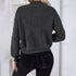 Back view of blonde woman in gray ribbed sweater and black fitted jeans showing relaxed fit and simple design