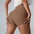 Close-up rear view of mocha brown athletic shorts with cream ruffle top, showcasing compression design