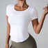 Woman wearing fitted white scoop neck t-shirt with olive green high-waisted leggings against gray background