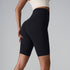Black high-waisted compression shorts with seamless design and sculpting silhouette, shown with white crop top