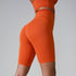 Side view of orange compression shorts showcasing seamless design and high waistband