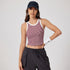 A woman wearing wine red striped crop top with white trim, navy cap, white wristband and gray cargo pants against clean white background