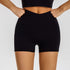 Black high-waisted compression shorts with crossover waist detail and matching sports bra