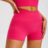 Hot pink compression shorts with signature crossover waistband and coordinating top