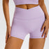 Lilac athletic shorts showcasing high-rise crossover waist detail and seamless construction