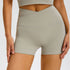 Light gray athletic shorts featuring crossover high waist and four-way stretch material
