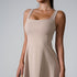 A model wearing nude square neck sleeveless dress with contoured seams and A-line silhouette against light gray background
