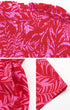 Close-up details of red tropical print fabric, smocked top, and hem stitching of the romper.