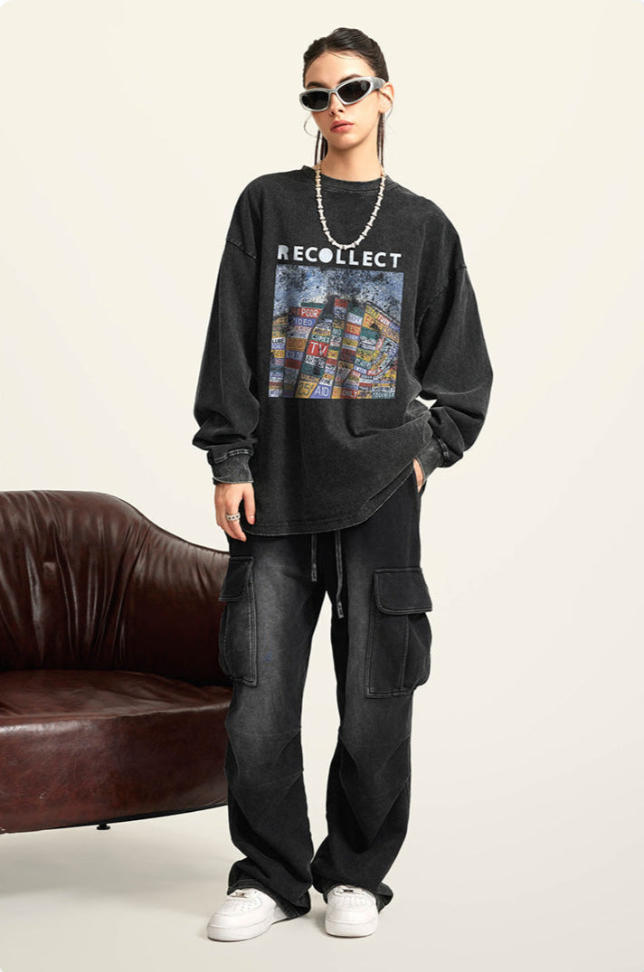 A female model wears a black "RECOLLECT" sweatshirt with a bold print, black cargo pants, and a chunky necklace, posing casually