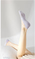 Lavender no-show socks shown on raised feet against white background