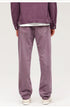 Purple wide-leg jeans with relaxed fit, shown with dark jacket and white sneakers