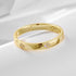 Gold wedding band with delicate flower-shaped diamond clusters arranged around polished band, displayed on white surface