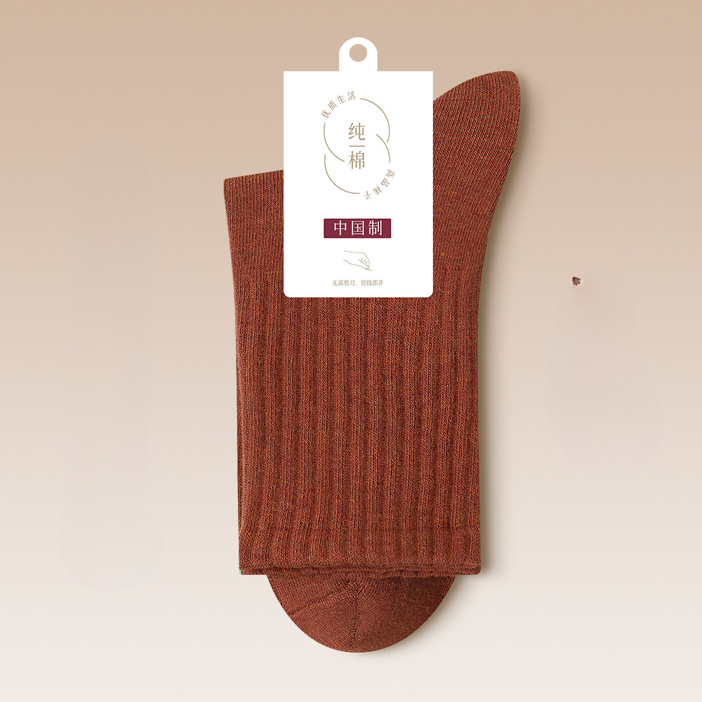 Brick red ribbed cotton sock with product authentication label