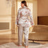 Back view of light silver satin pajama set with floral print, showcasing the wrap-style jacket and wide-leg pants