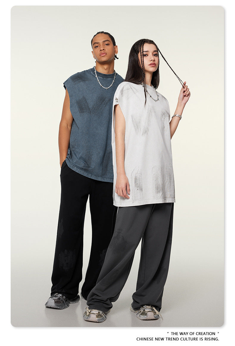 Two models in gray and white oversized t-shirts with black and gray pants against white background